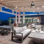 Custom community amenities with multiple seating areas, string lighting and annual flowers.