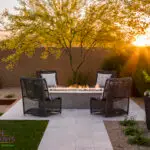 Custom backyard design with desert landscaping, fire pit and outdoor seating area.
