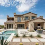 Custom backyard design with organized planting, natural stone accents and multiple seating areas.