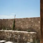 Custom backyard design with natural stone accents, Jesus steps and metal scupper water feature.