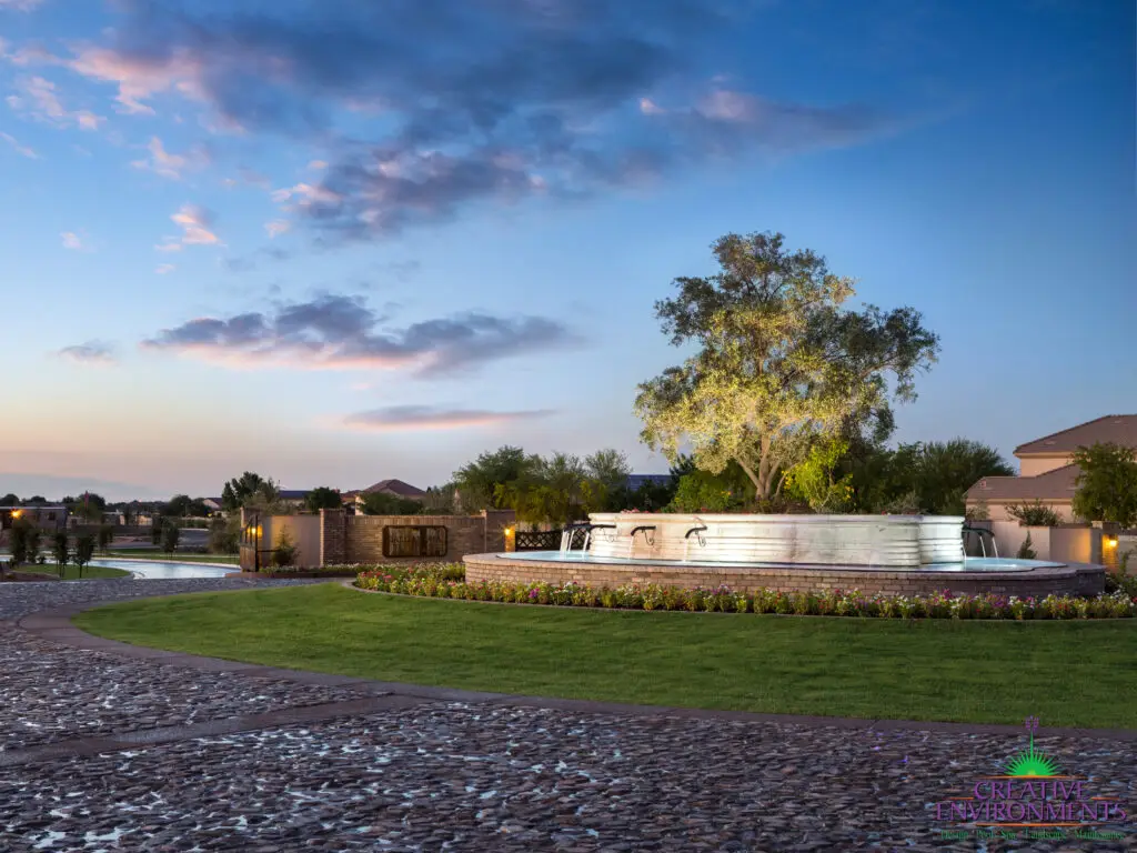 Custom community entrance with large water feature, roundabout driveway and real grass.