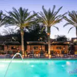Custom community amenities with blue pool, water fountain feature into pool and multiple cantilevered shade structures.