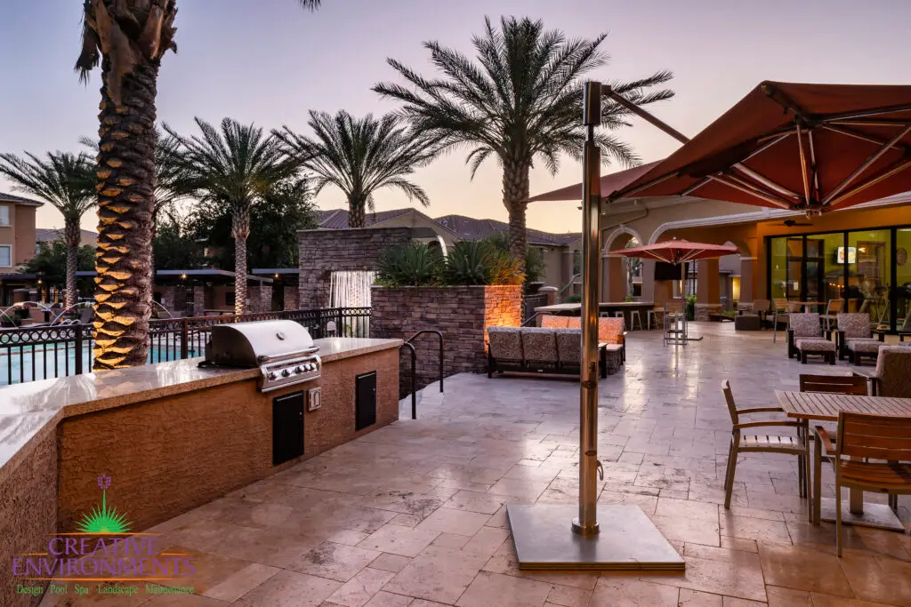 Custom community amenities with outdoor BBQ, water feature into pool and natural stone decking.