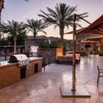 Custom community amenities with outdoor BBQ, water feature into pool and natural stone decking.