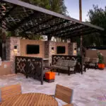 Custom community ammenities with decorative metal patterns, cantilevered shade structure and multiple outdoor seating areas.