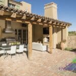 Custom backyard design with outdoor kitchen -- complete with hood, outdoor bbq, storage and outdoor TV.