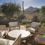 Custom backyard with multiple seating areas and desert views.