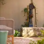 Custom faucet water feature with outdoor seating area.