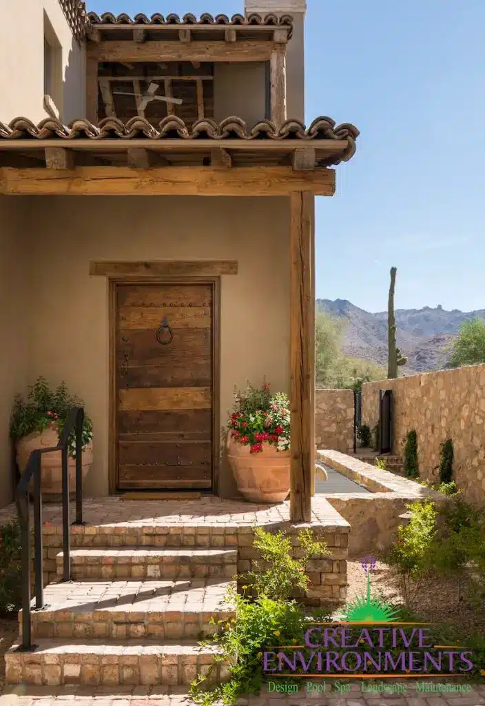 Custom front yard design with large flower plantes and brick steps.