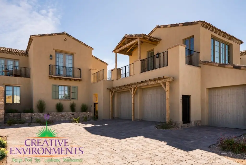 Custom front yard design with paver driveway.