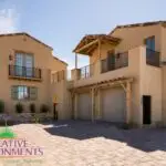 Custom front yard design with paver driveway.