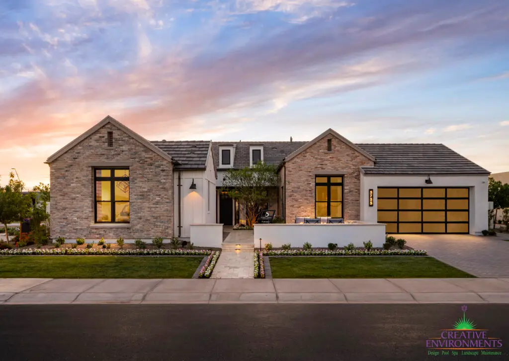 Custom front yard design with organized planting, real grass and unique front entryway.