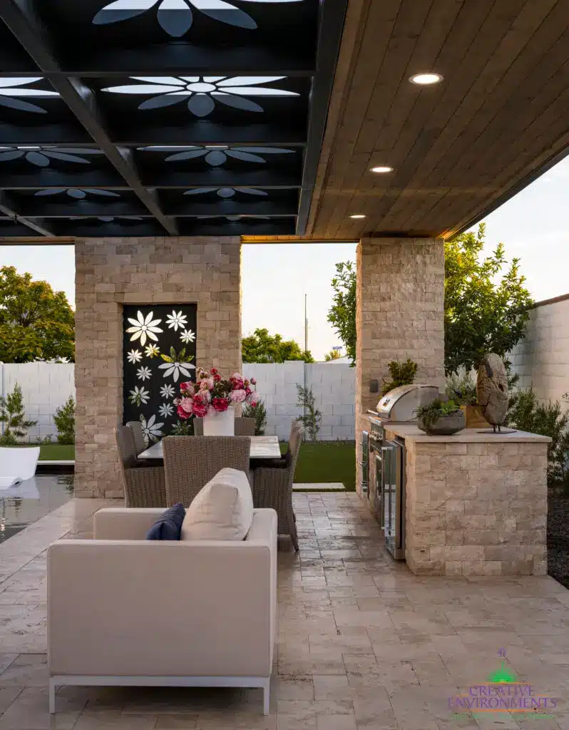 Custom metal shade structure with recessed lighting, floral metal cutouts and multiple seating areas.