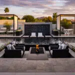 Custom backyard design with water wall into pool, Jesus steps and cabanas.
