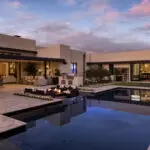 Custom backyard design with large pool, sunken fire pit and natural stone steps.