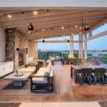 Custom community amenities with angled shade structure, multiple seating areas and floor-to-ceiling fireplace.