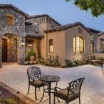 Front yard design with courtyard, multiple seating areas and flowers.