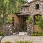 Front yard design with unique entryway and metal gate.