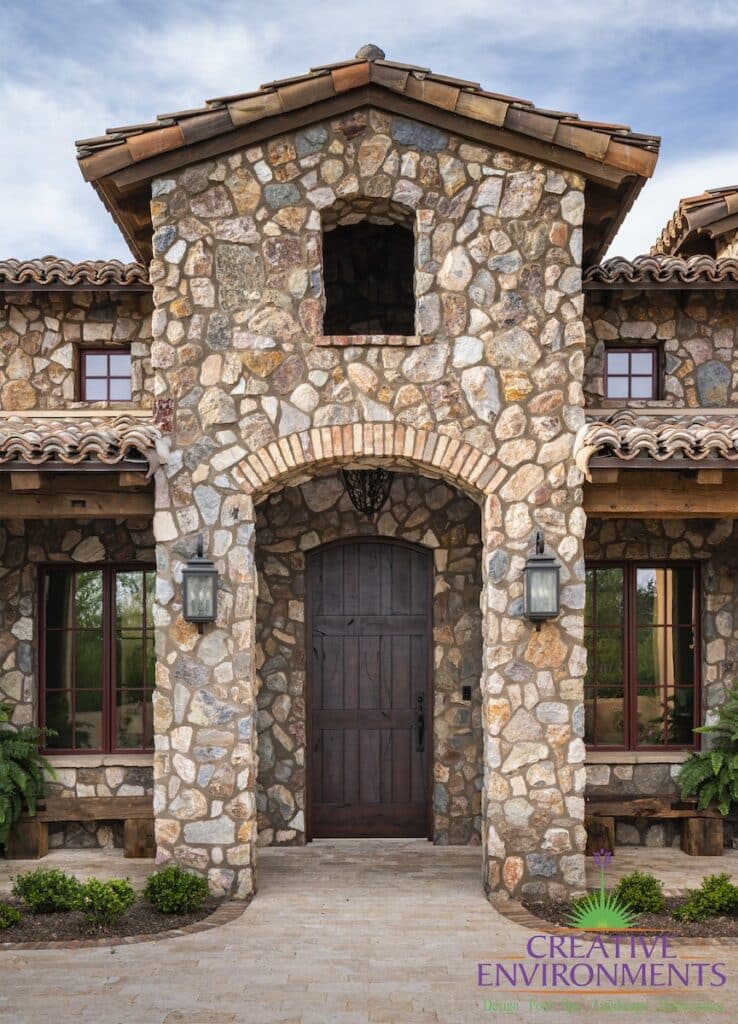 Front yard design with small plants and unique entryway.