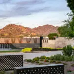 Custom community entrance with metal scupper water features, organized planting and luxury design.