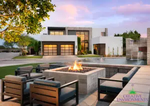 Custom community amenities with fire pit, metal scupper water feature and real grass.