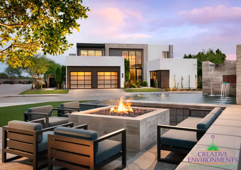 Custom community amenities with fire pit, metal scupper water feature and real grass.