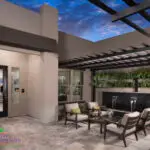 Custom entry way design with slatted metal shade structure, living wall and black water feature.