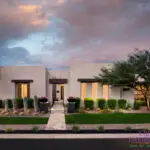 Custom front yard design with up lighting, natural stone paver walkway and artificial turf.