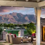 Custom community landscape design with shade structure with multiple seating areas, shade structure and real grass.
