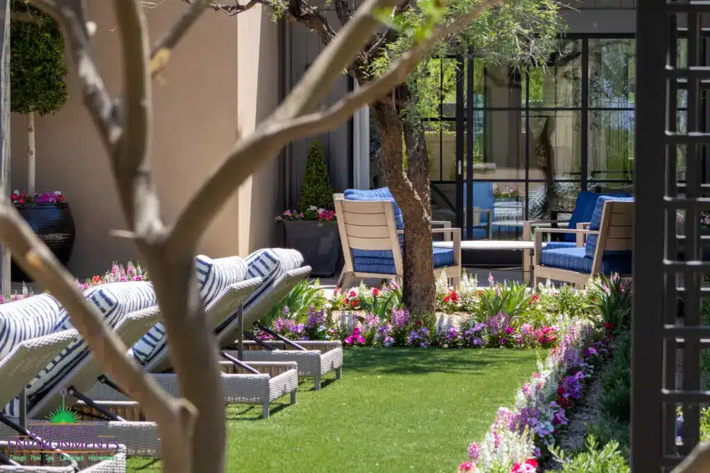 Custom backyard design with multiple seating areas, annuals and large planters.