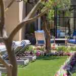 Custom backyard design with multiple seating areas, annuals and large planters.