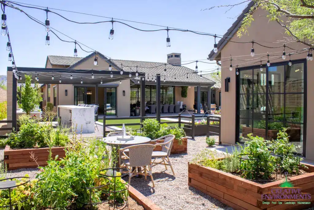 Custom backyard design with string lights, gardening corner and multiple seating areas.