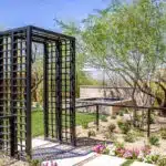 Custom metal archway, metal fencing and water feature in zen garden.