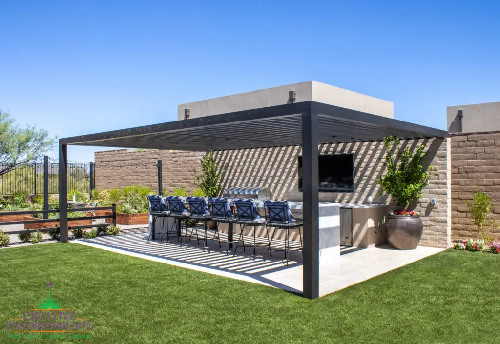 Custom backyard design with slatted metal shade structure, large planters and outdoor entertainment area.