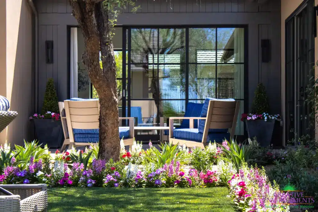 Custom backyard design with outdoor entertainment area, large planters and annuals.