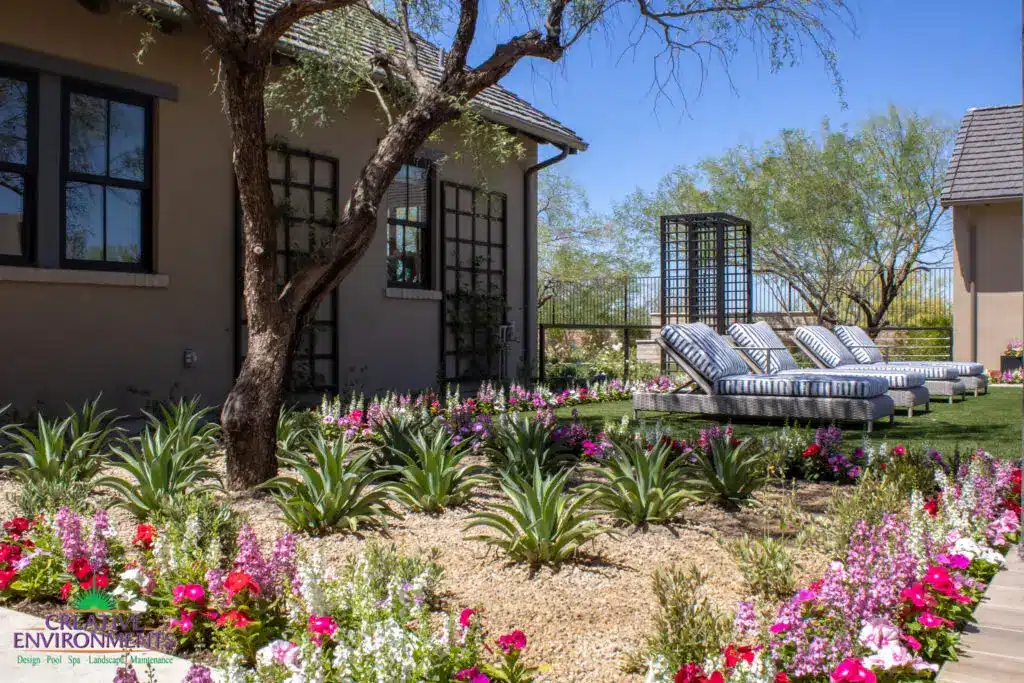 Custom backyard design with metal trellis, organized planting and artificial turf.