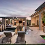 Custom backyard design with cantilevered shade structure, metal scupper water feature, zero-edge pool, Jesus steps and angled shade structure.