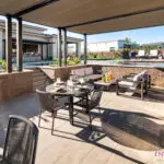 Backyard design with sunken entertainment area with multiple seating areas.