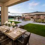 Backyard design with real grass and outdoor dining area.