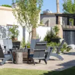 Backyard design with deco-tile wall and seating area around fire pit.