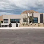 Custom front yard design with desert landscape design, metal sign and metal planters.