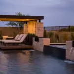Custom backyard design with multiple seating areas, metal scupper water feature into pool and desert contemporary vibes.