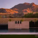 Custom backyard design with metal planters, metal scupper water feature and raised black spa.