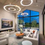 Custom indoor/outdoor living experience with up lighting, sunken fire pit into pool and trees.