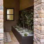 Custom entryway with living wall and natural stone pillars.