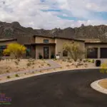 Custom front yard design with organized planting, roundabout and natural stone walkway.