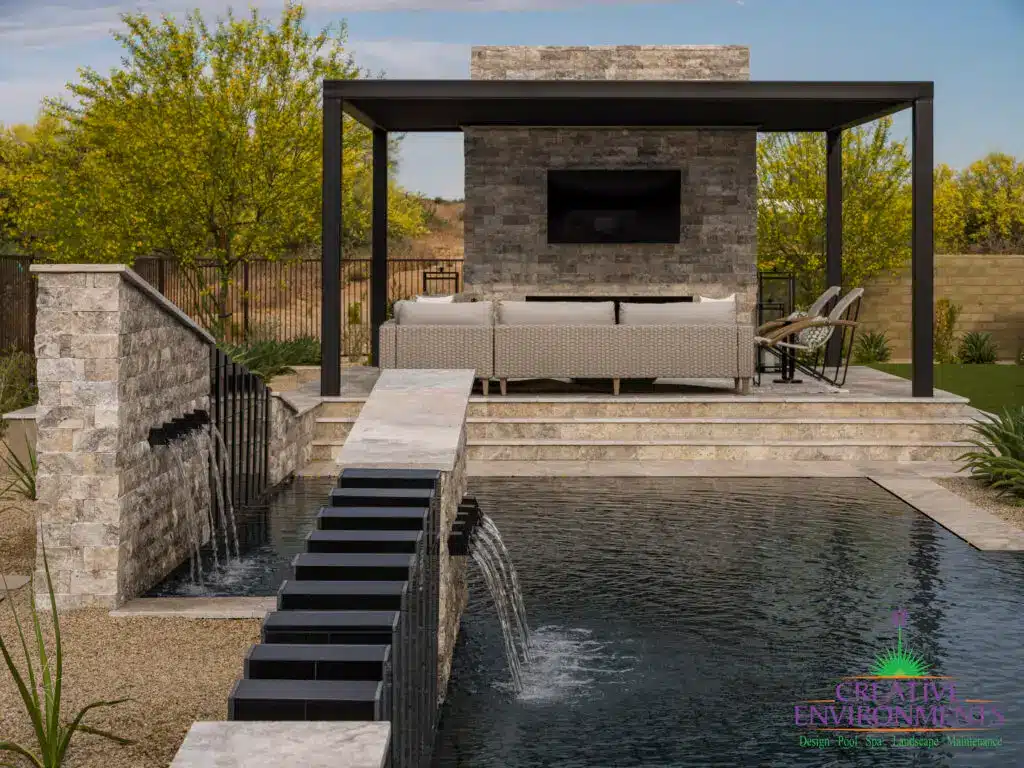 Custom backyard design with multiple angled water features, slatted metal statement piece and desert landscape design.