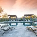 Custom backyard design with zero-edge pool, cantilevered shade structures and multiple seating areas.