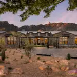 Front yard design with paver driveway and desert plants.