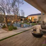 Backyard design with multiple seating areas and natural stone steps.